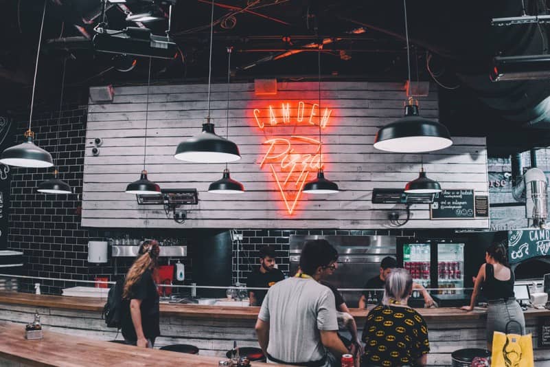 Pizza shop with happy guests.